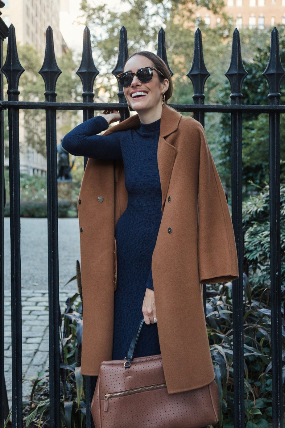 Louise Roe wearing camel coat with navy dress 