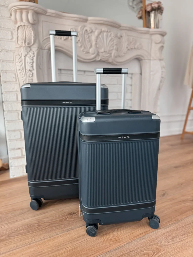 Two suitecases sitting against a wall.