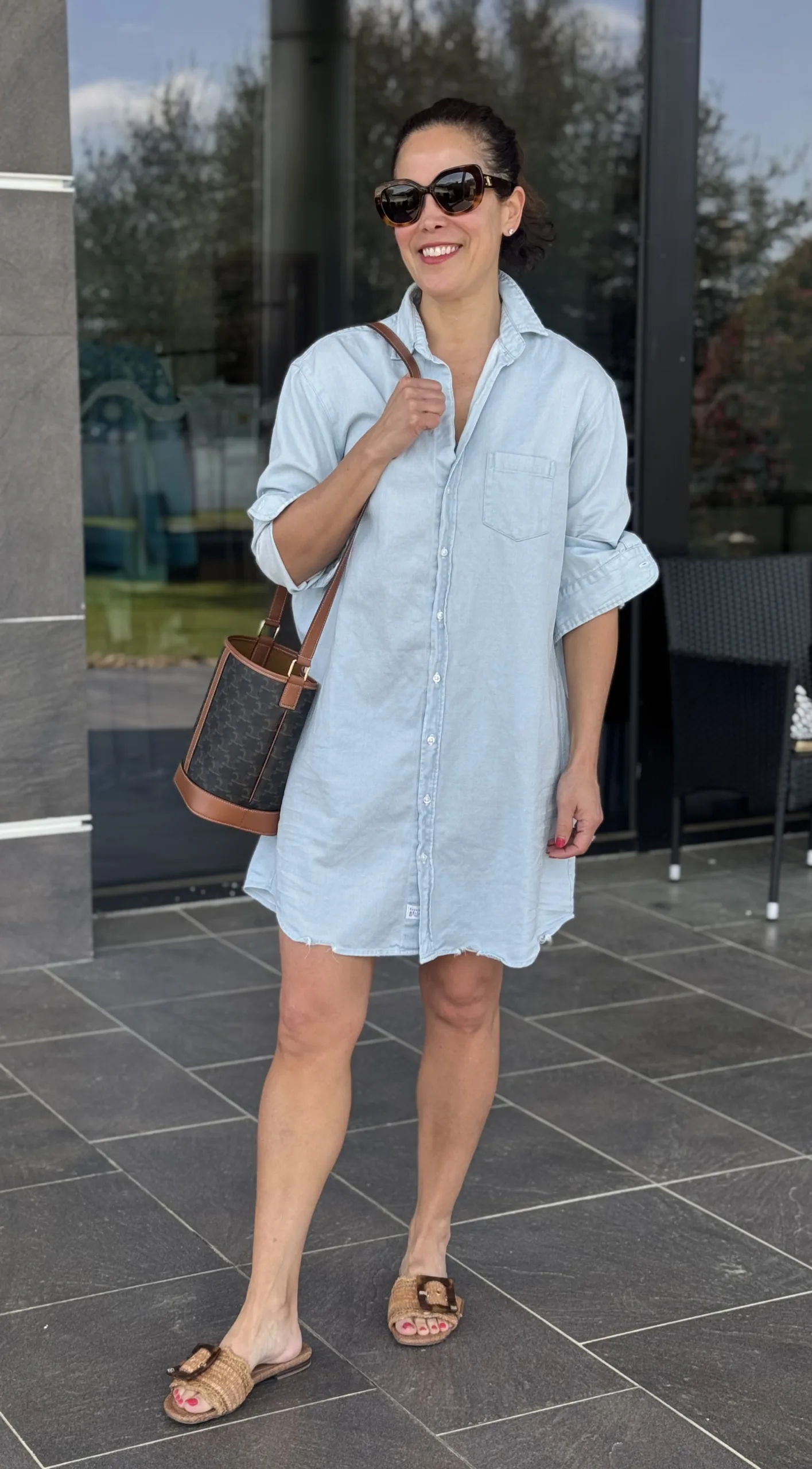 woman wearing denim dress and sandals. 