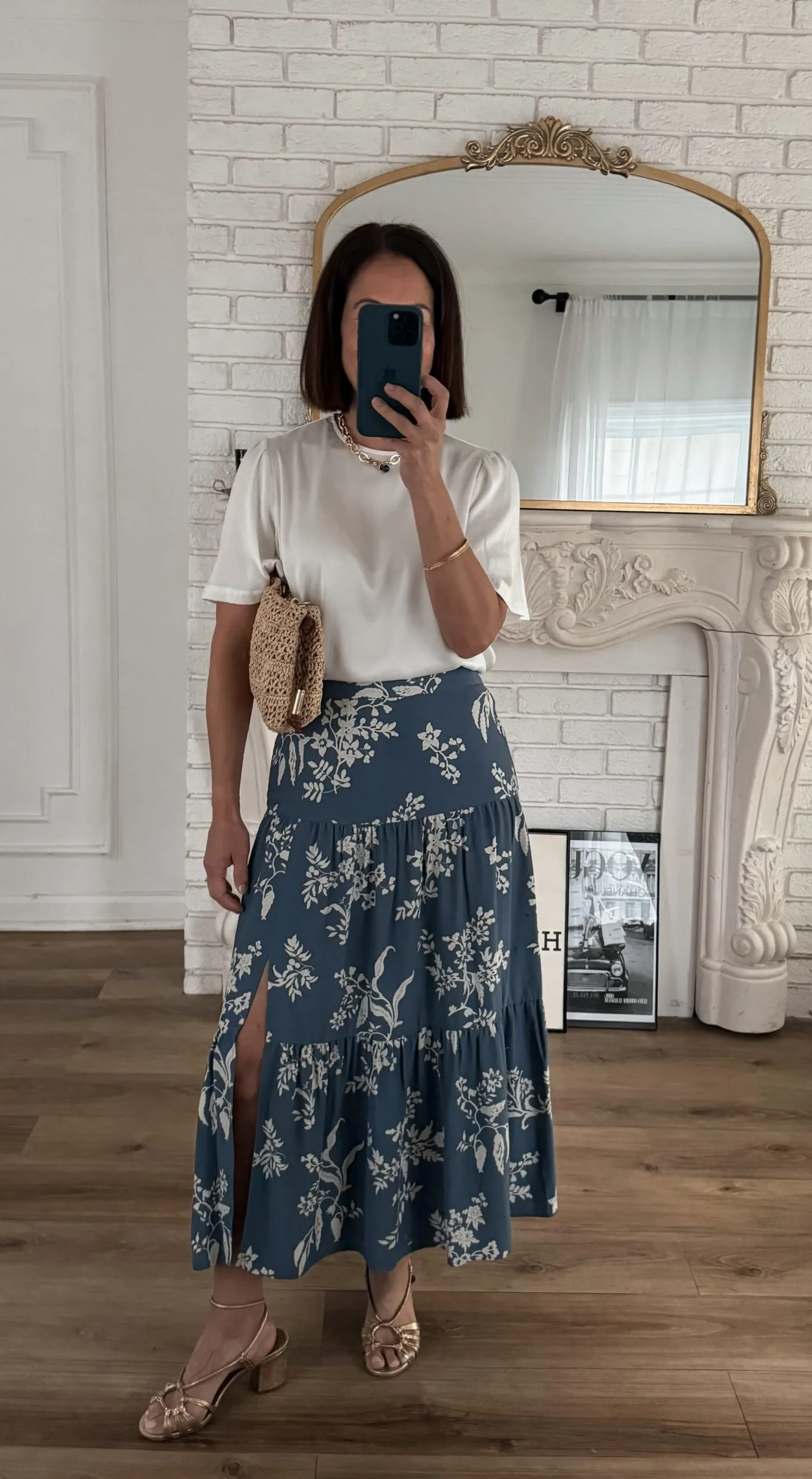 Woman in skirt with silk top and sandals.