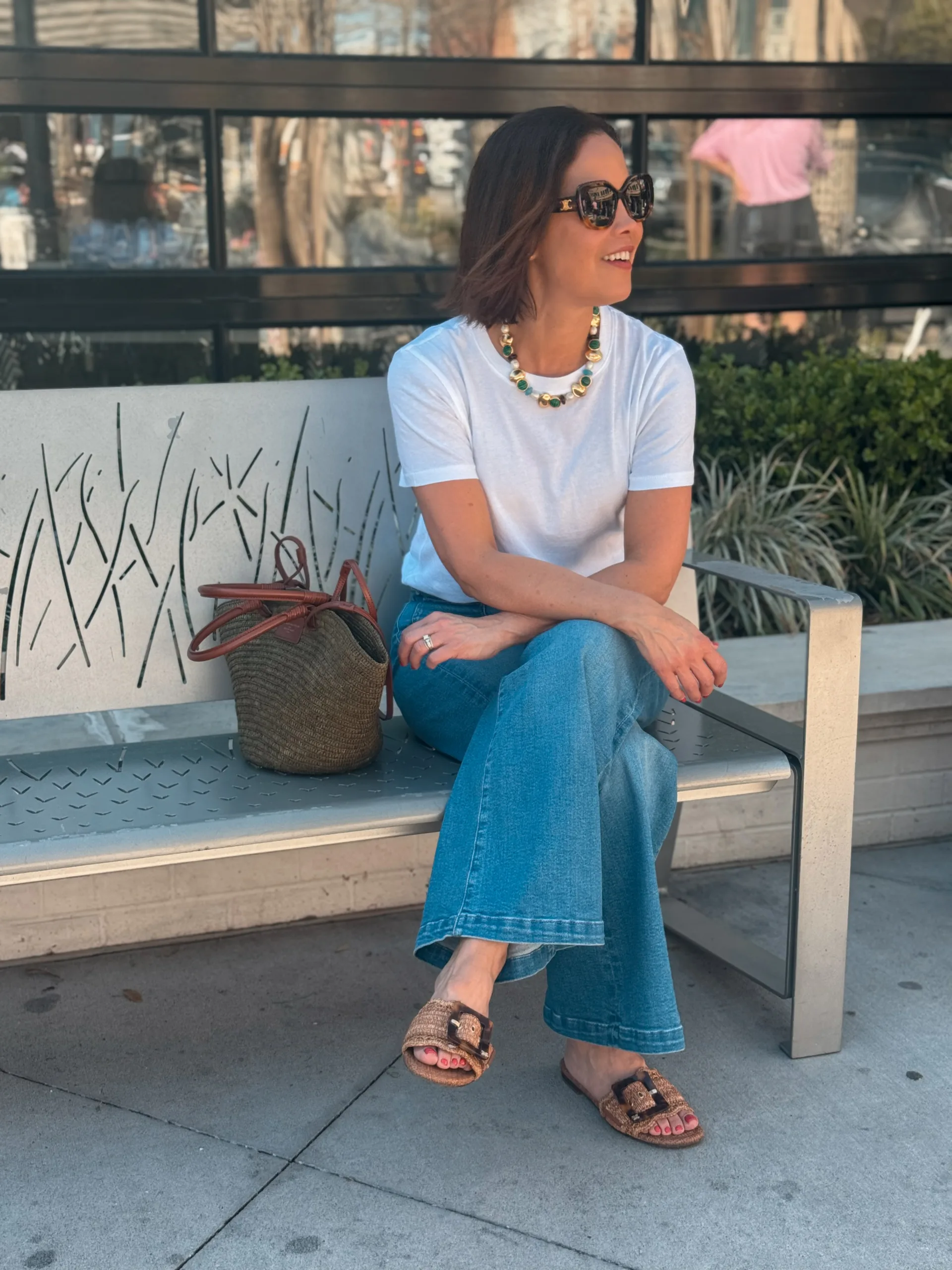 woman wearing white tshirt with denim and sandals. 