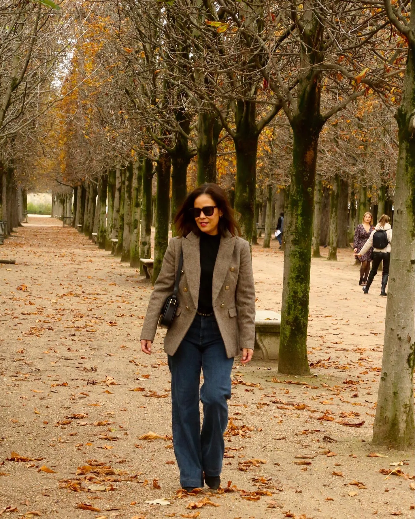 Woman walking in tuileries in Paris.