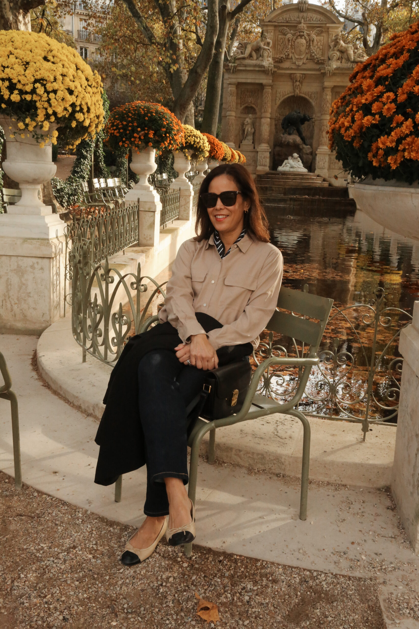 Woman wearing silk top in luxembourg in paris in november for what to pack and wear.