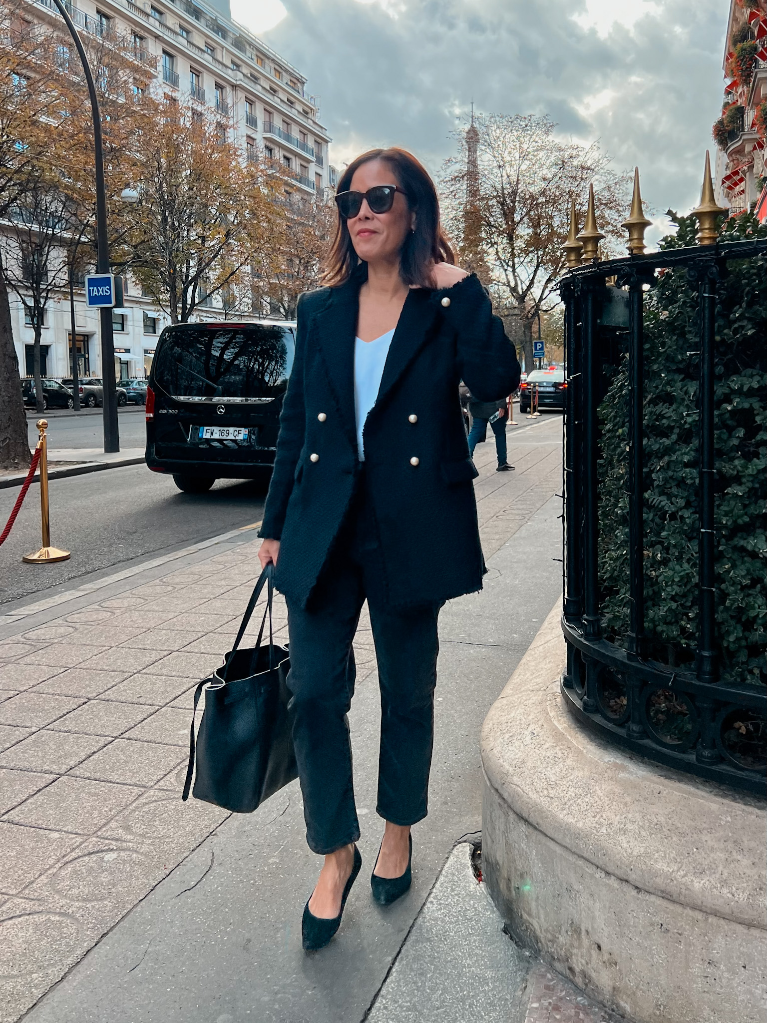 Woman in black blazer and pumps in paris in november.