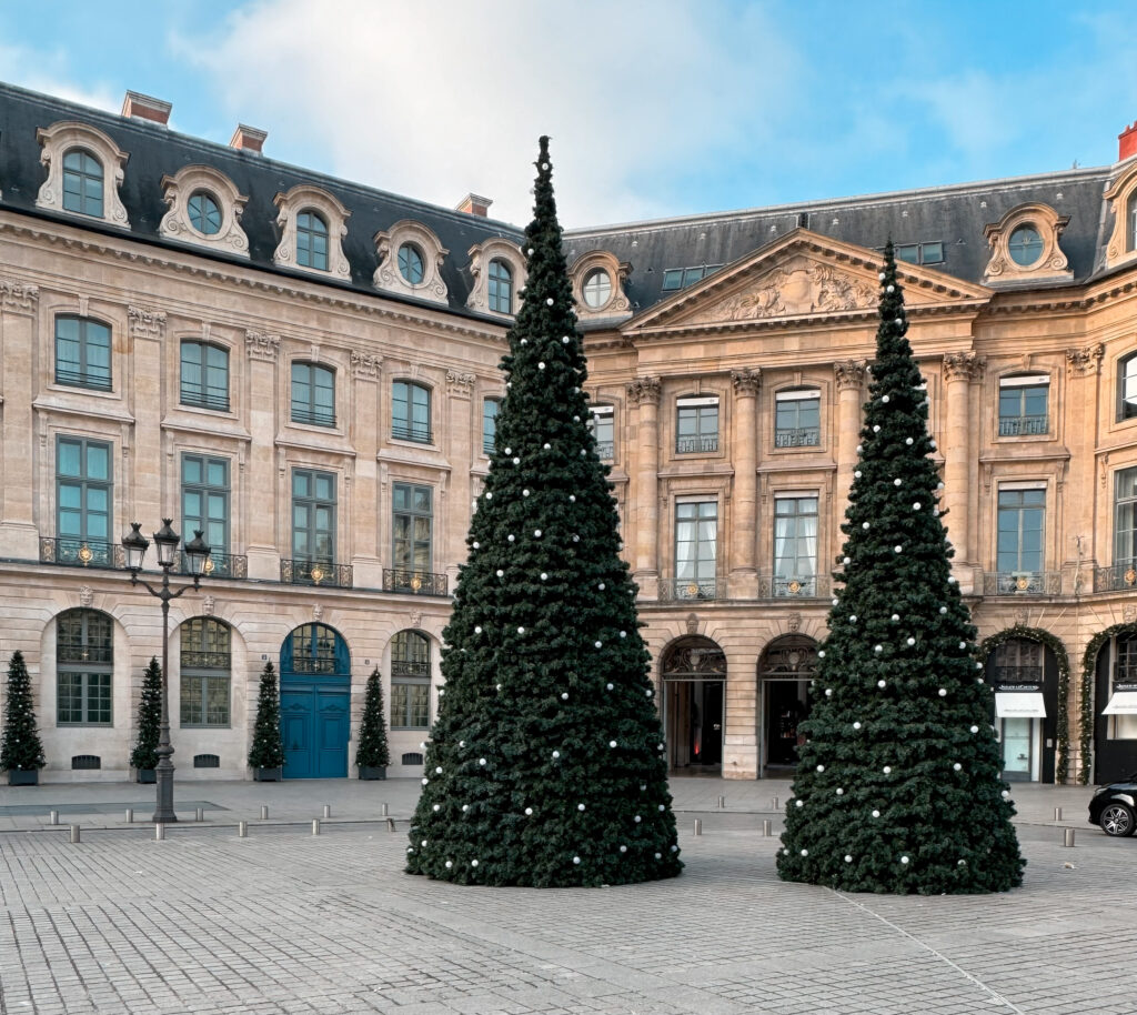 Place Vendome in Paris at the holidays with trees.