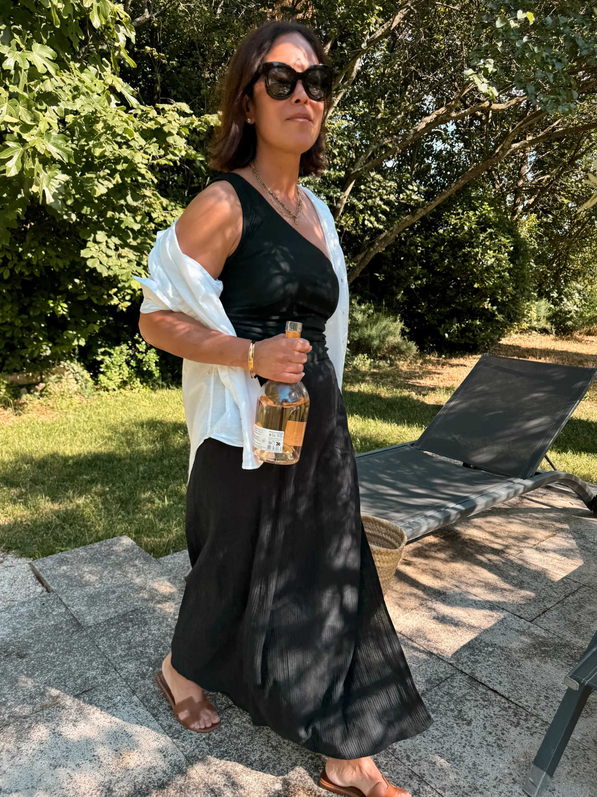 Woman in black swimsuit with white cover up.