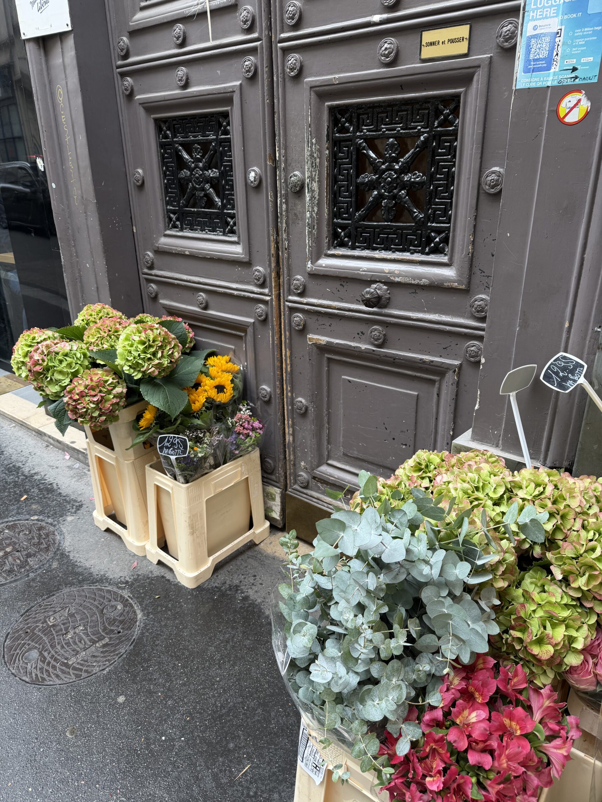Autumn flowers outside a Paris shop doorway