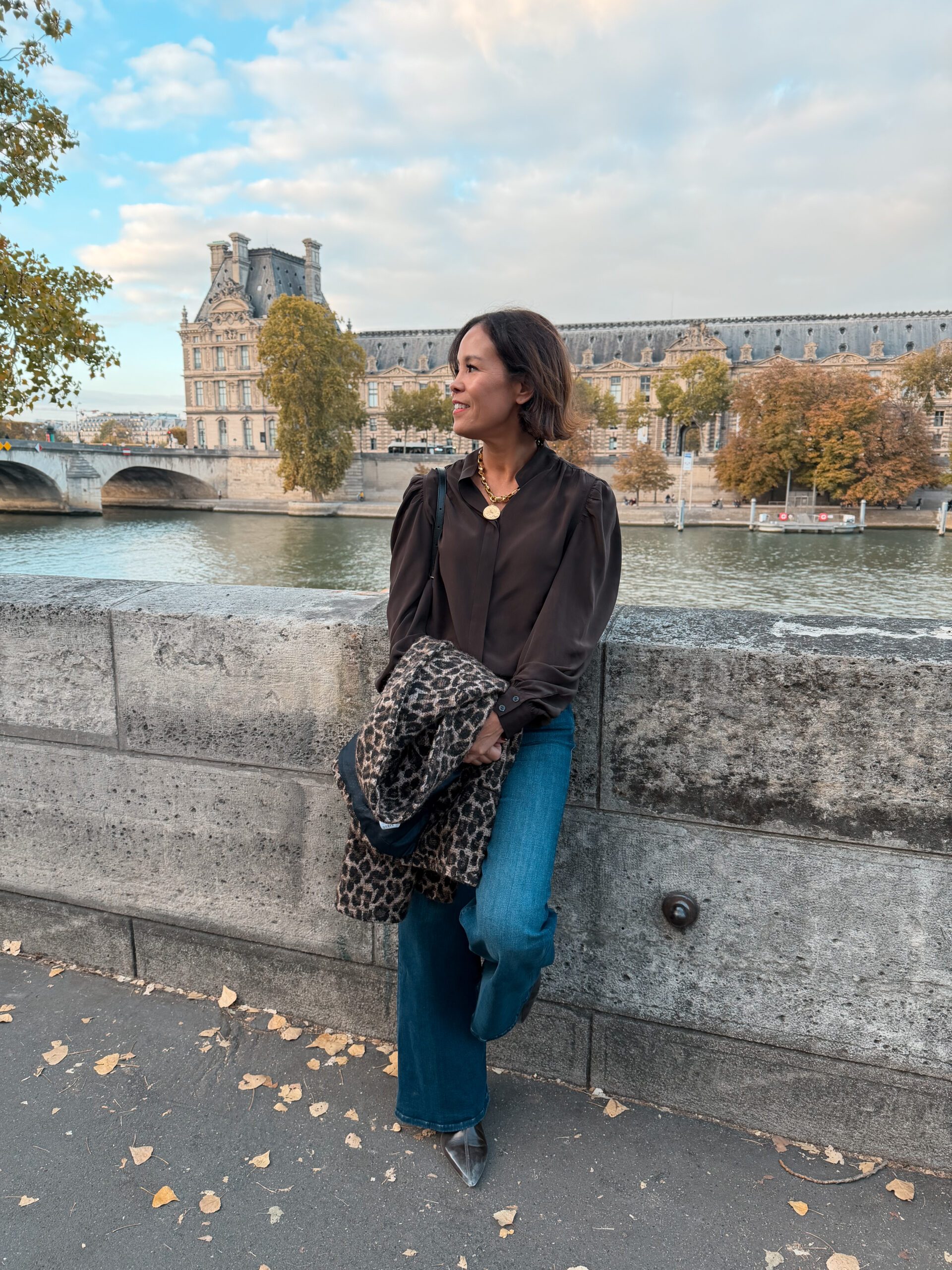 Fall outfit by the Seine with the Louvre in Paris