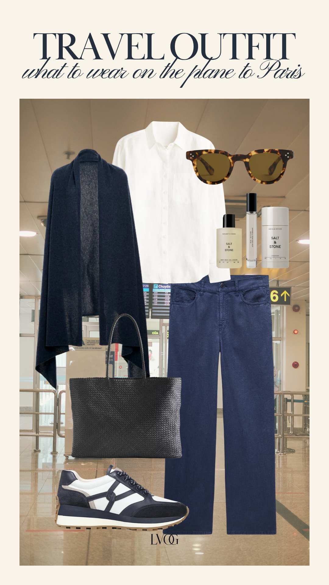 Navy cashmere wrap, white button-down shirt, dark denim and woven tote — travel outfit for the plane to Paris
