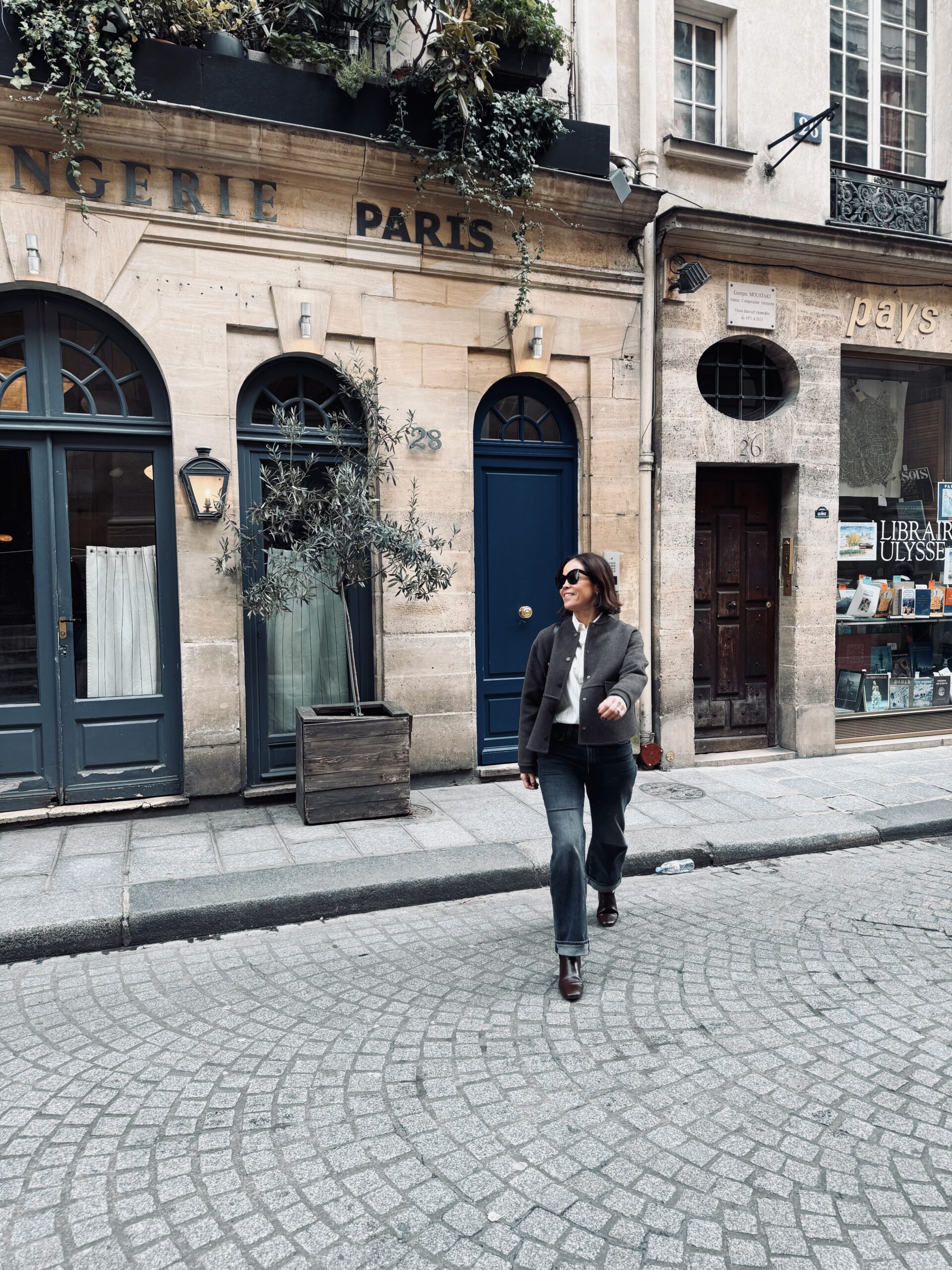 Woman walking in Paris across the street in winter.