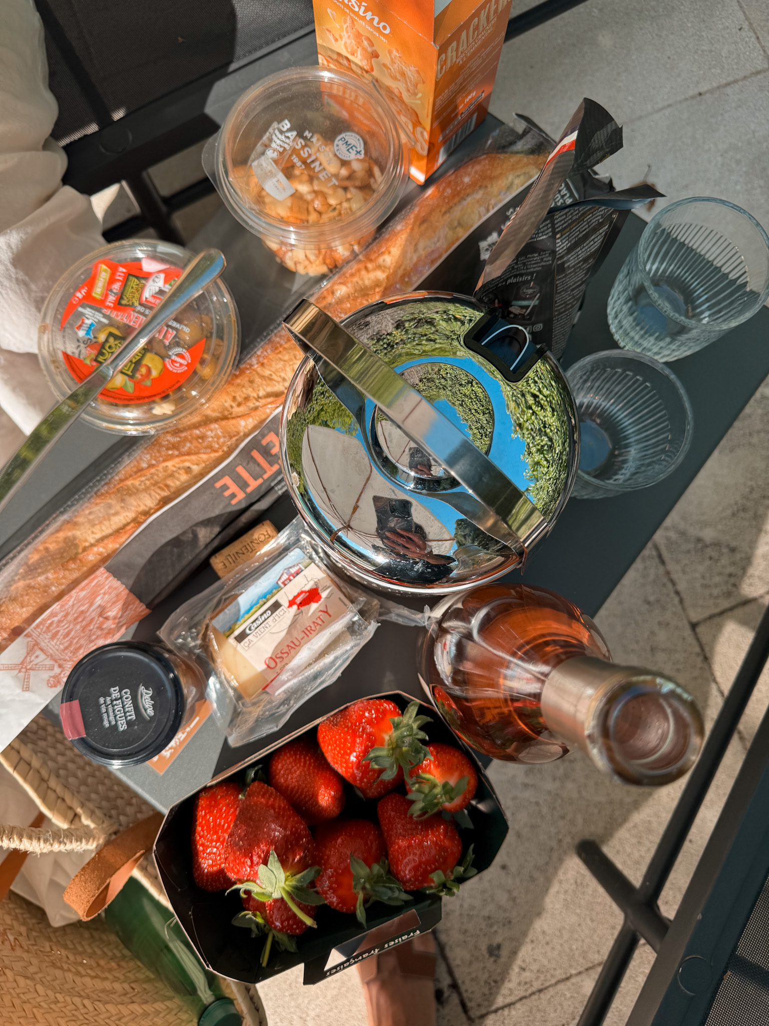 Picnic with bread, cheese, strawberries, and rosé from the Lourmarin Friday market in Provence