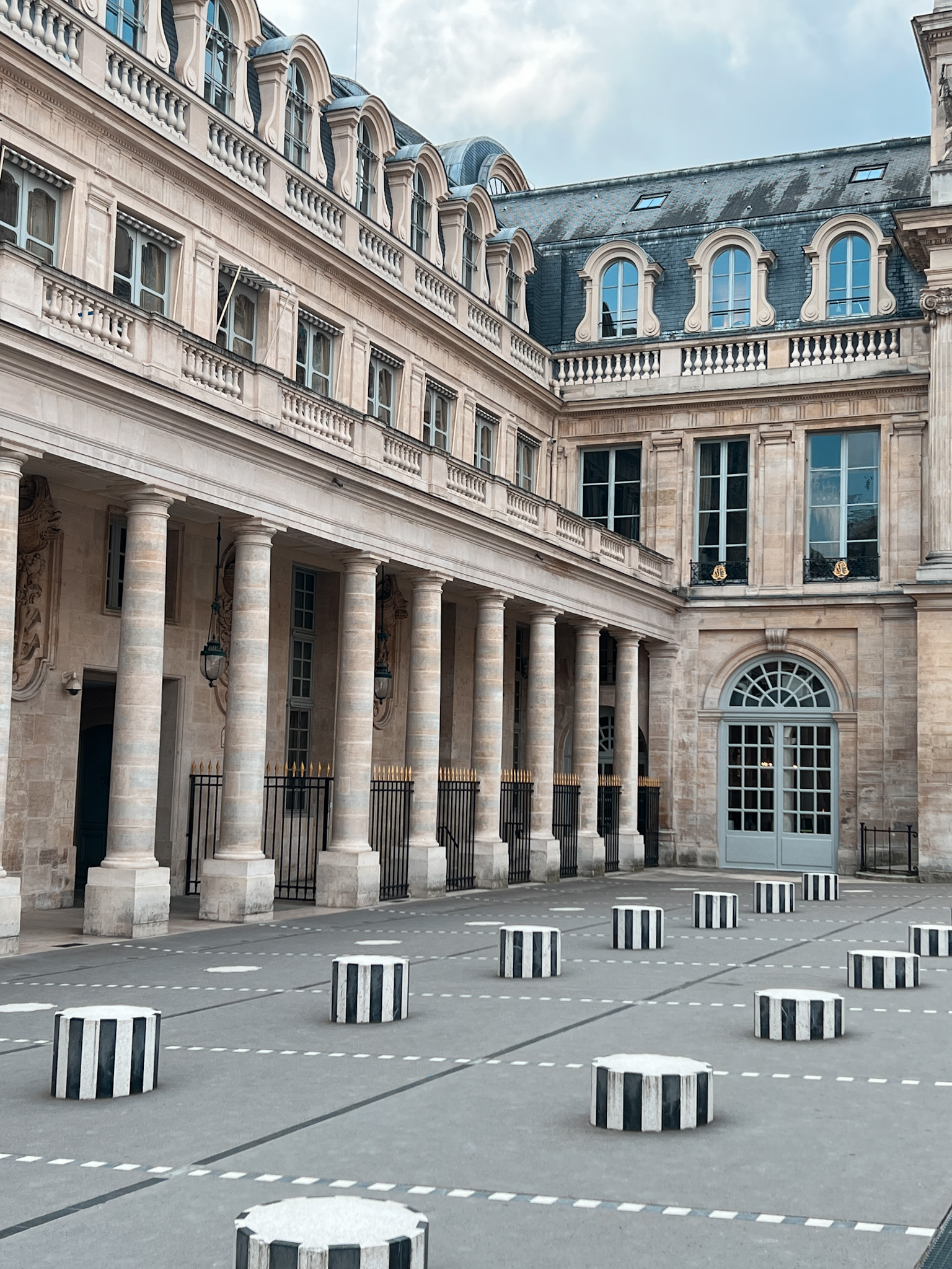 Black and white Palais Royal columns in Paris during the morning before anyone arrives.