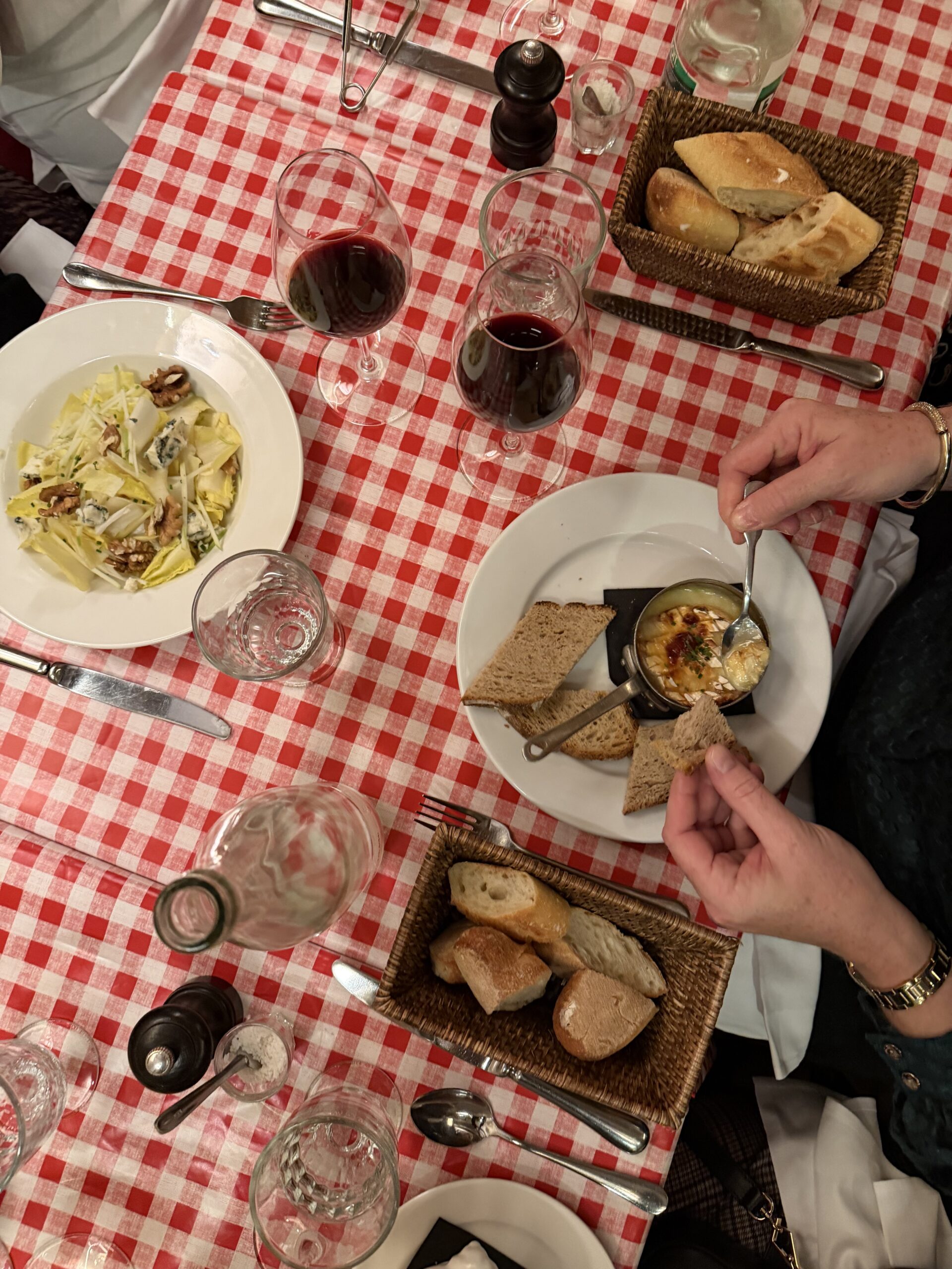 Classic French bistro dinner at Chez Fernand in Saint-Germain-des-Prés with red wine, bread, and traditional dishes