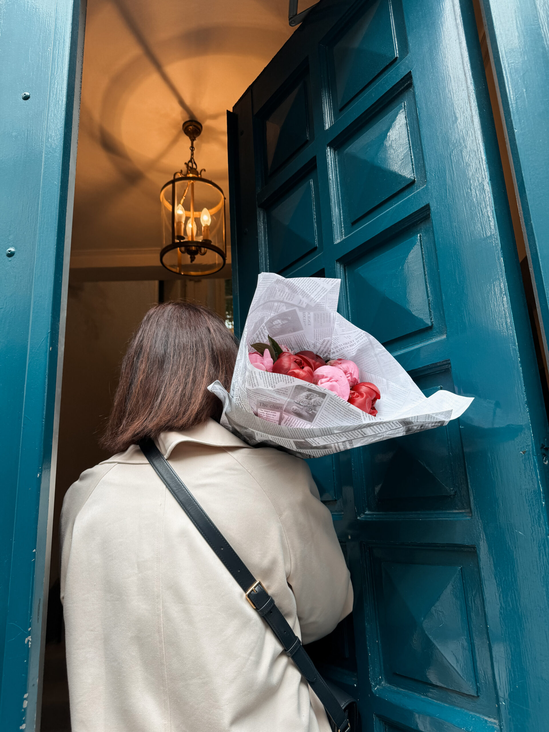 Woman with big bouquet of flowers from the market.