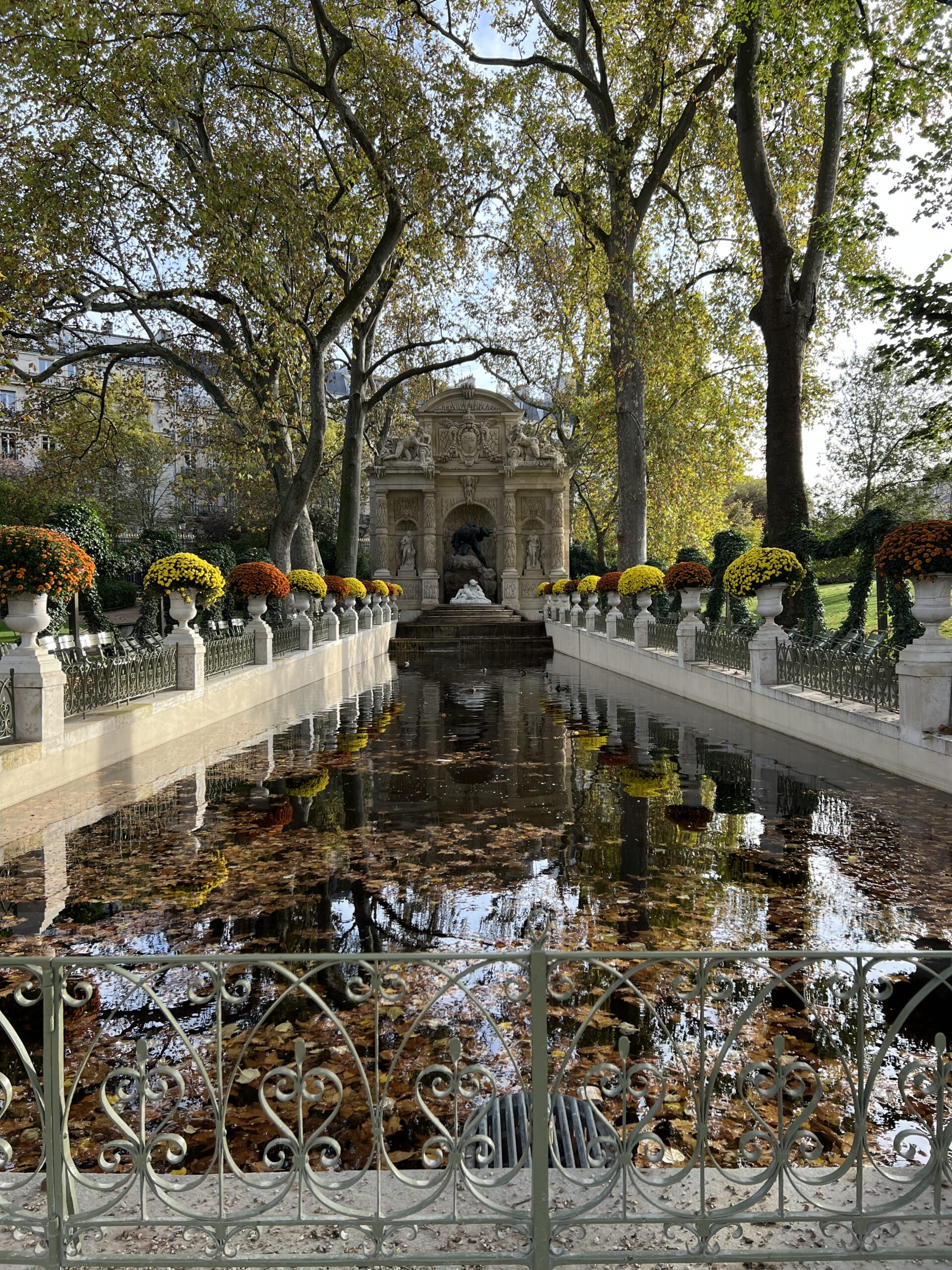 Sitting near the Medici Fountain in Jardin du Luxembourg on a fall day in Paris