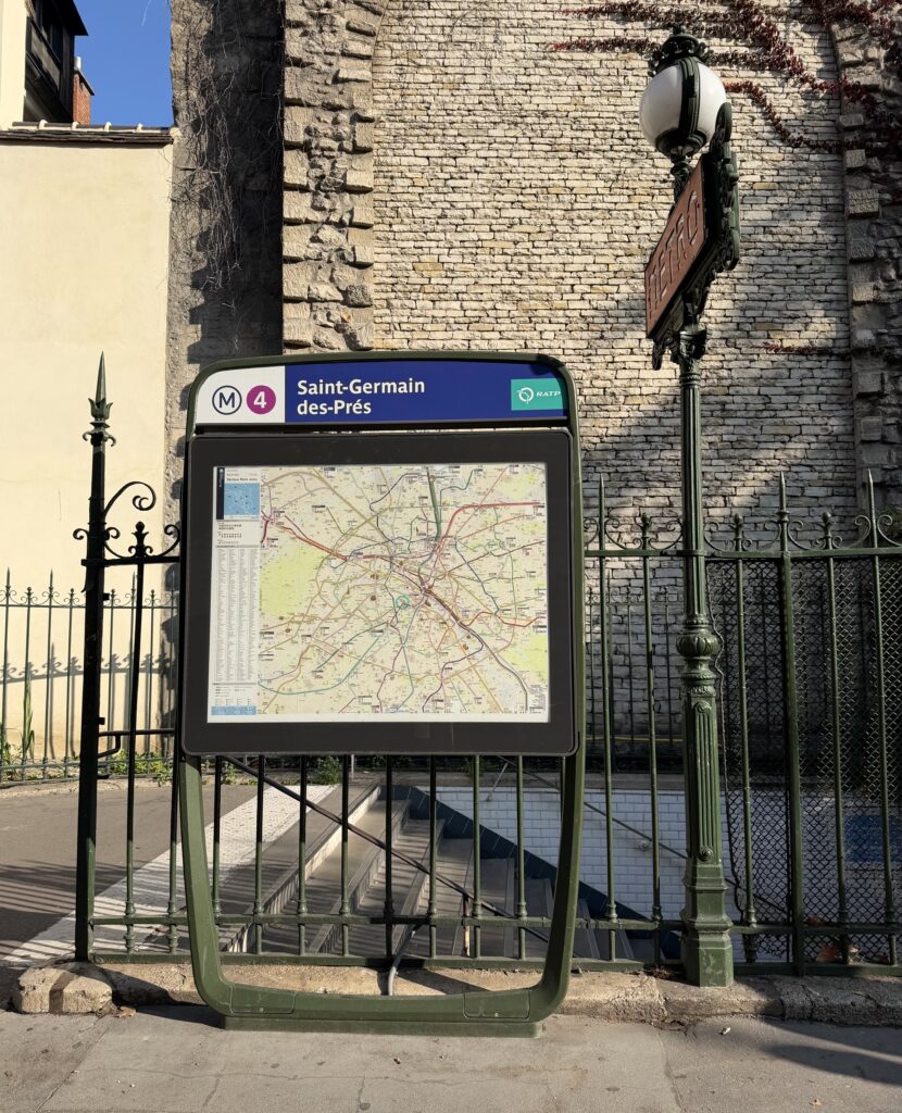 Saint-Germain-des-Prés metro station entrance on Line 4 in Paris with neighborhood map