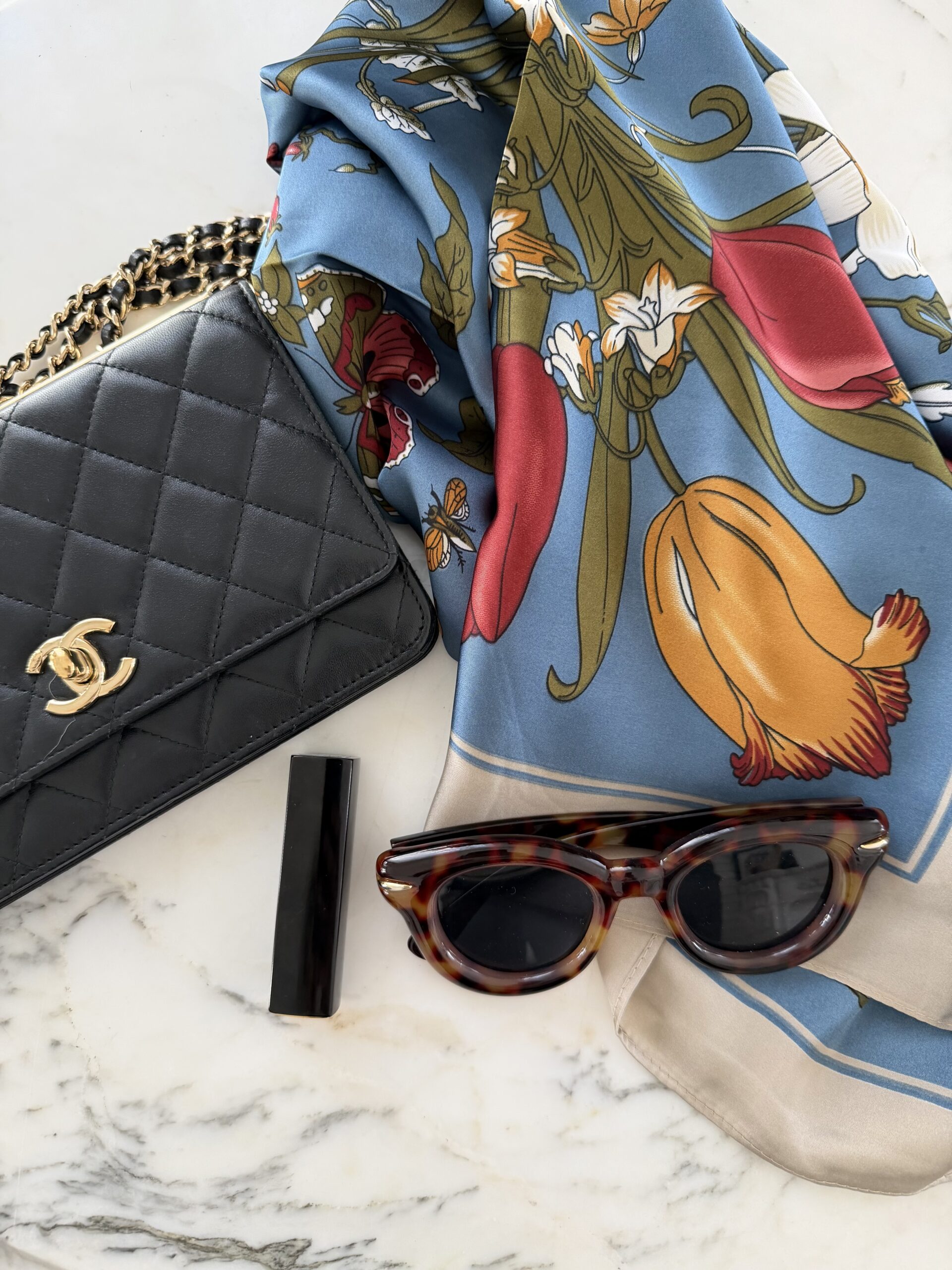 Paris accessories for May — silk scarf, quilted chain bag, tortoiseshell sunglasses and red lipstick
