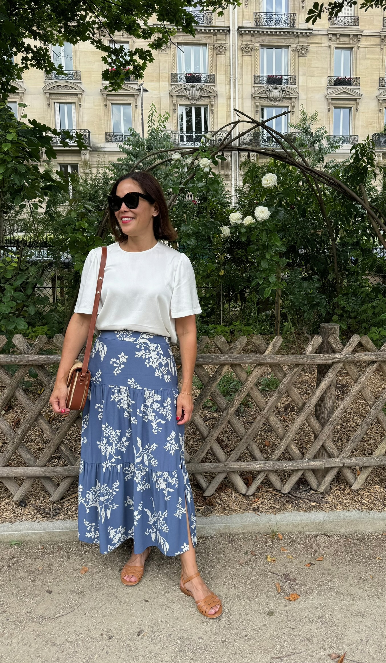 What to wear in Paris in July — white t-shirt with blue floral midi skirt and cognac sandals
