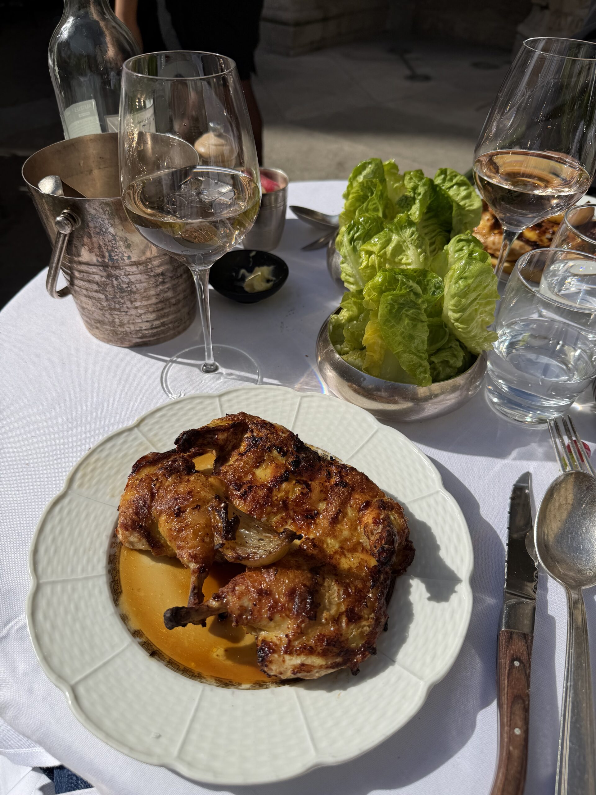 Chicken and lettuce on a Sunday with a pretty tablecover for dinner.